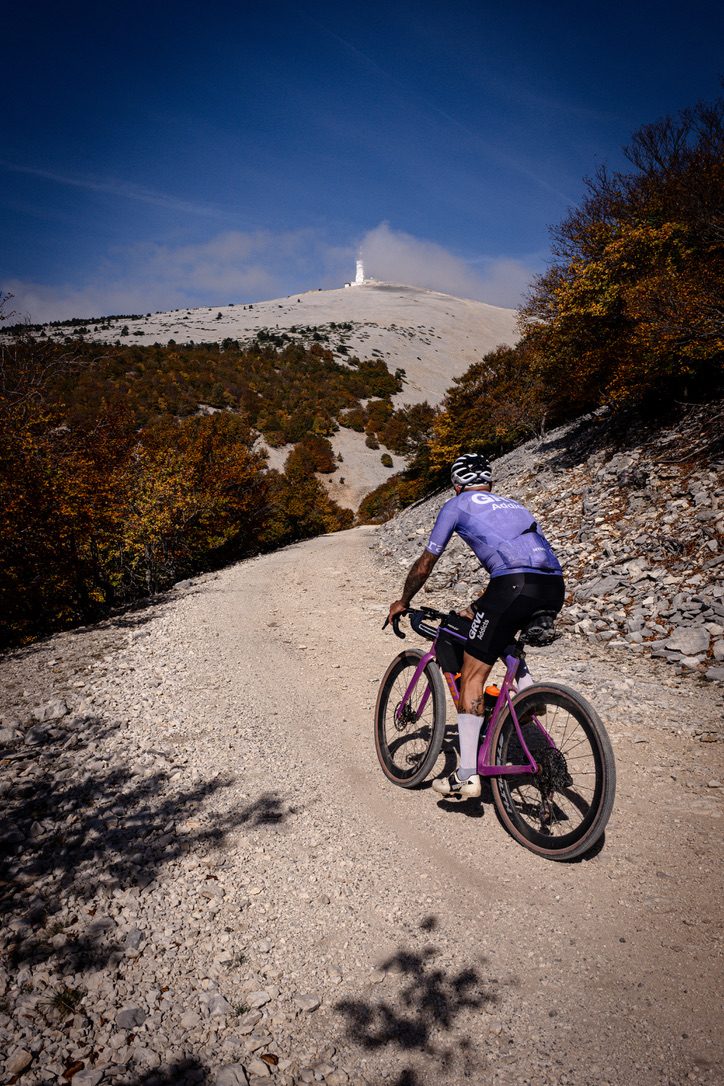 Gravelrijder klimt over een steenslagpad naar de top van de Mont Ventoux
